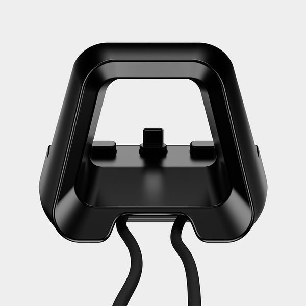 Black docking station with a handle, featuring two connectors and attached cables.