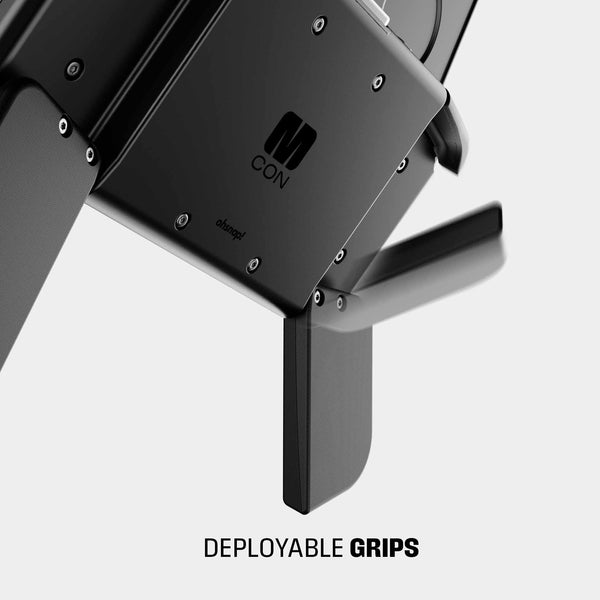Close-up of a black device featuring deployable grips and the 