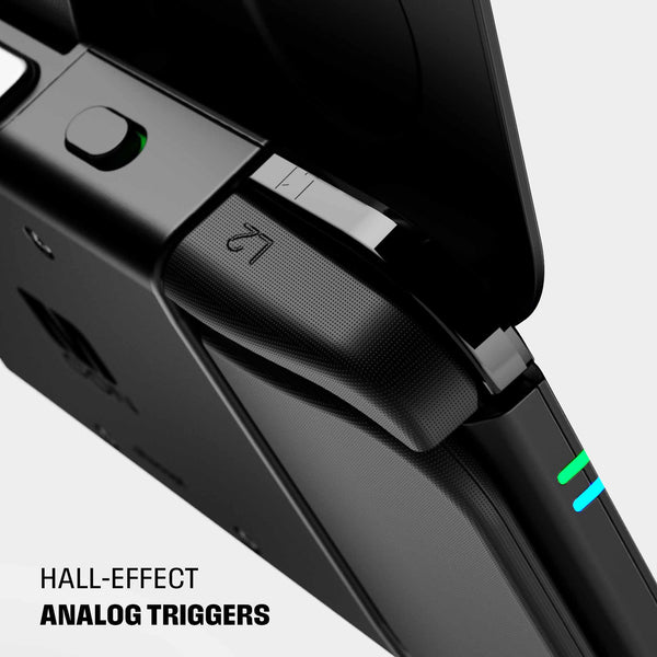 Close-up of a gaming controller showing hall-effect analog triggers and a button with a green indicator light.