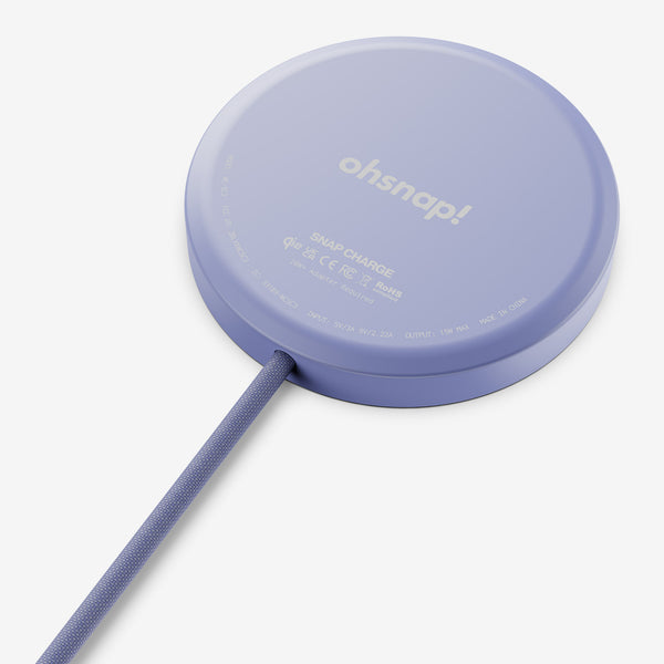 Round purple wireless charger with a textured cable, featuring branding and technical specifications on the surface.