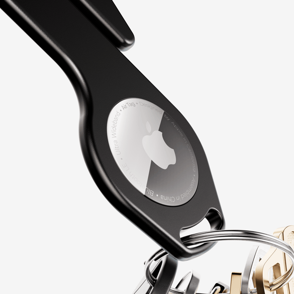 Black key loop with a circular holder for an AirTag and attached metal keyring.
