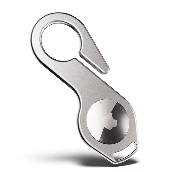 Metal key loop with a circular holder for an AirTag, featuring a hook for attachment.