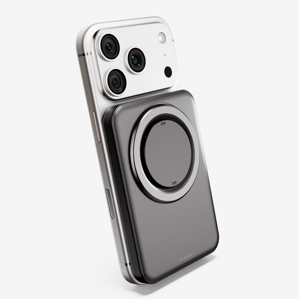 Magnetic battery pack attached to a smartphone, featuring a circular charging area and indicator lights.
