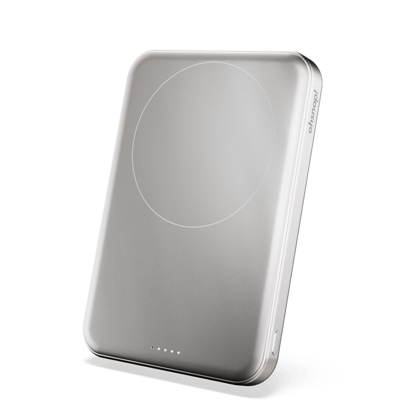 Silver portable charger with a circular charging area and indicator lights on the bottom edge.