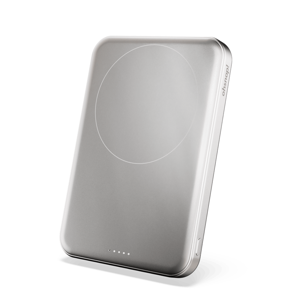 Silver portable charger with a circular charging area and indicator lights on the bottom edge.