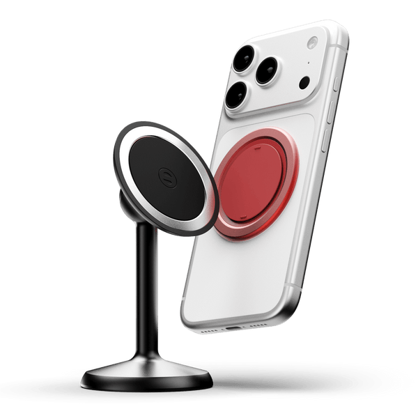 Magnetic phone stand with a black and silver base, holding a phone with a red magnetic attachment.