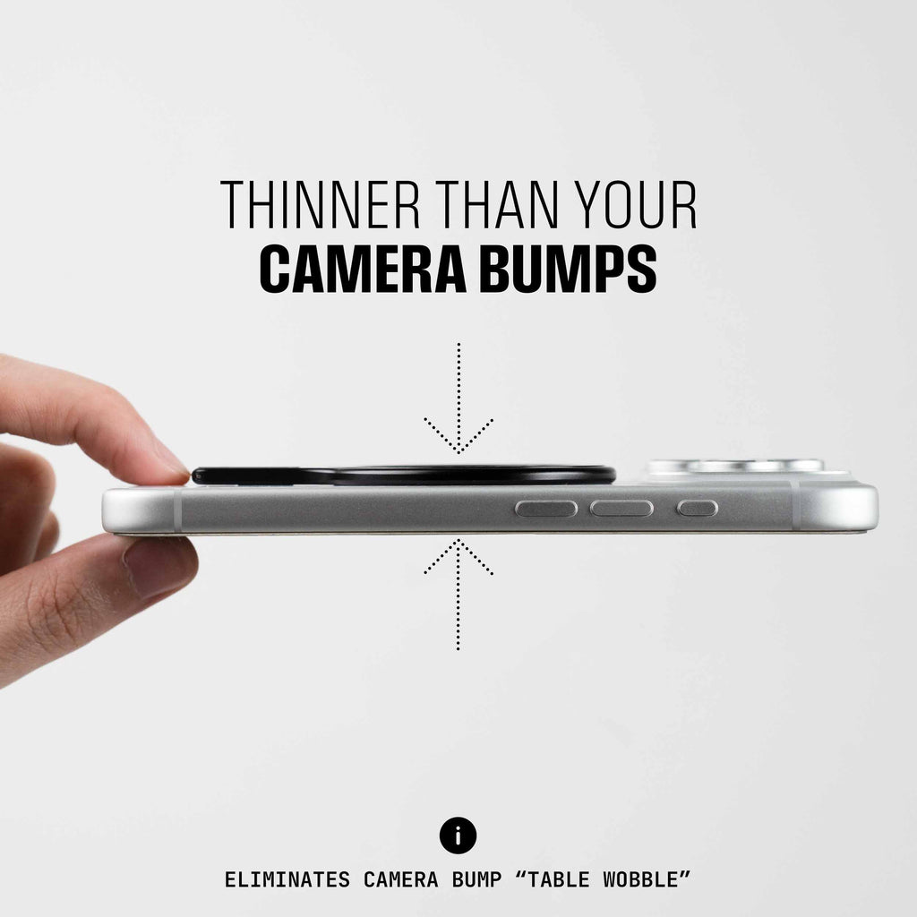 A hand holds a smartphone with a thin accessory attached, showing its slim profile compared to the camera bump.