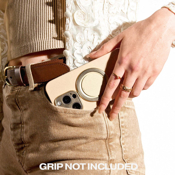 Phone case partially visible in a pocket, held by a hand with rings, wearing a textured top and beige pants.
