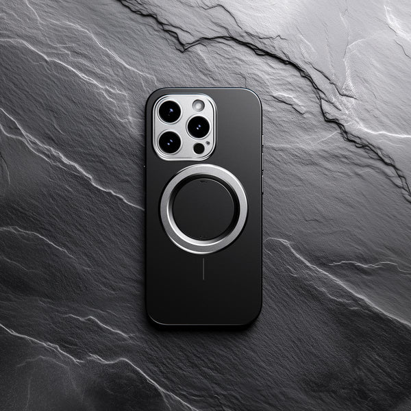 Black snap case for a smartphone with a circular magnetic attachment on the back, placed on a textured stone surface.