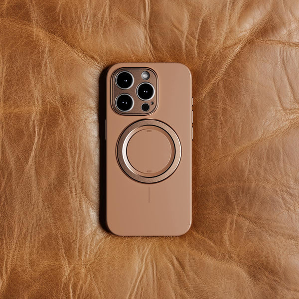 Brown phone case with a circular magnetic attachment, placed on a textured leather surface.
