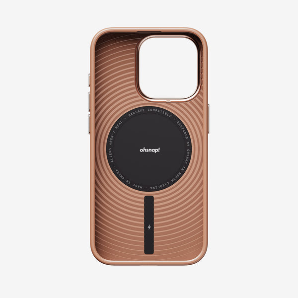 Rose gold phone case with a circular MagSafe-compatible design and textured lines on the back.