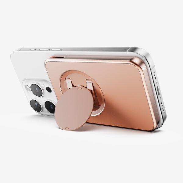 Wallet attachment in rose gold color, mounted on the back of a smartphone, featuring a circular grip.