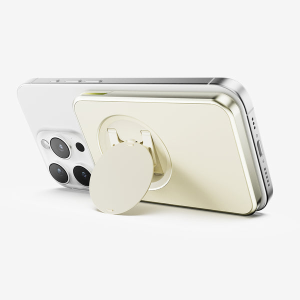 Wallet attached to the back of a smartphone, featuring a circular grip in a gold finish.