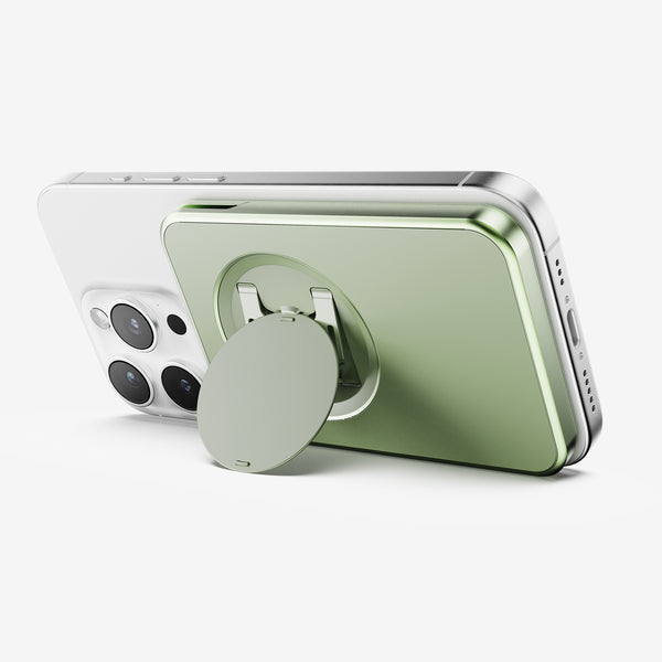 Wallet attachment in green color mounted on the back of a smartphone, featuring a circular grip.