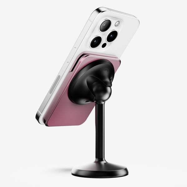 Wallet attached to a smartphone, mounted on a black stand, displaying a pink cardholder.
