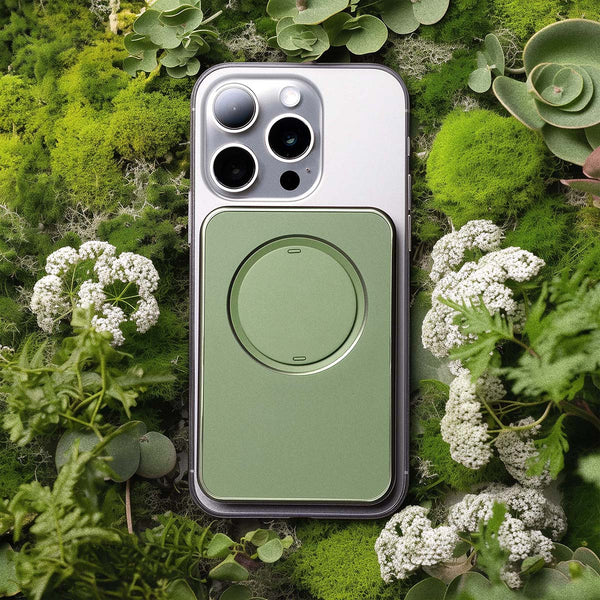 Green Snap Grip Wallet attached to a smartphone, surrounded by various green plants and foliage.