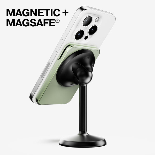 Magnetic wallet attached to a smartphone on a black stand, showcasing a green cardholder.