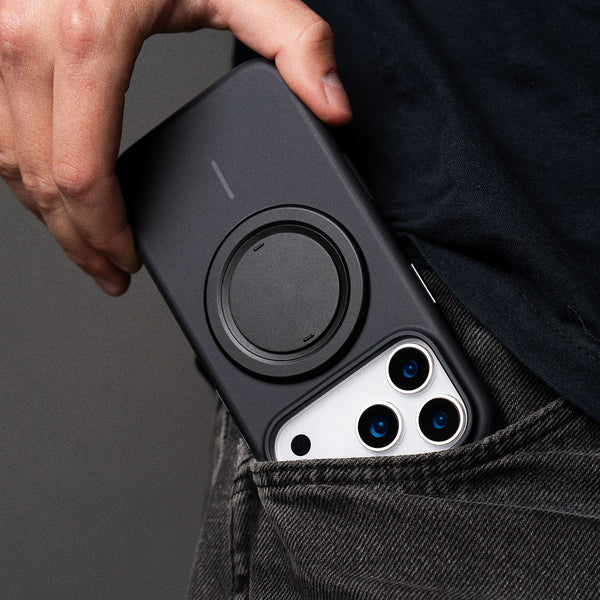 Black case with grip for iPhone, partially visible in a pocket, showing camera and grip design.