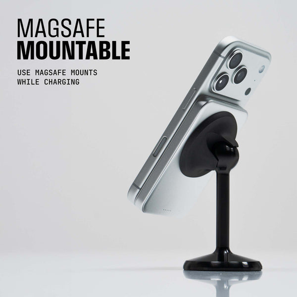 MagSafe mount with a black stand holding a silver smartphone at an angle.