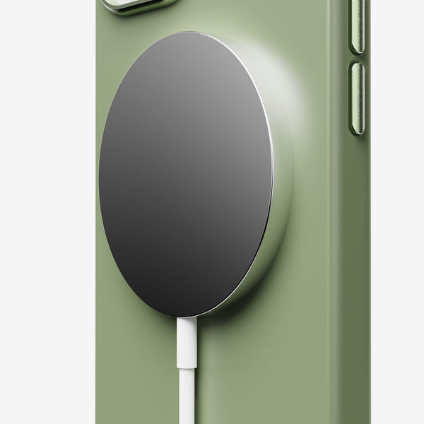 Magnetic charging pad attached to a green phone case with a white cable connected.