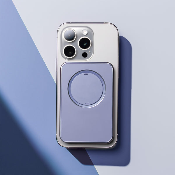 Purple snap grip wallet attached to the back of a smartphone on a light blue surface.