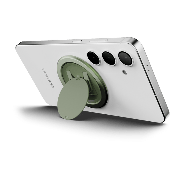 Phone with a circular green grip attached to the back, positioned to support the device upright.