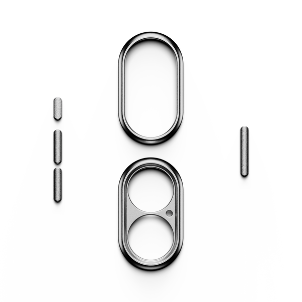 Trim kit components including two oval frames and several small cylindrical pieces on a white background.