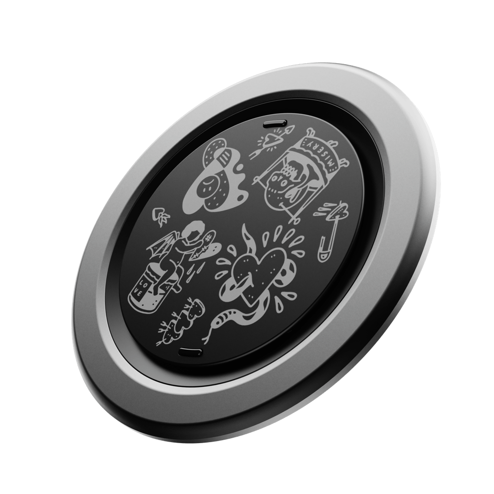 Circular grip with a black surface featuring various white doodles and a silver outer rim.