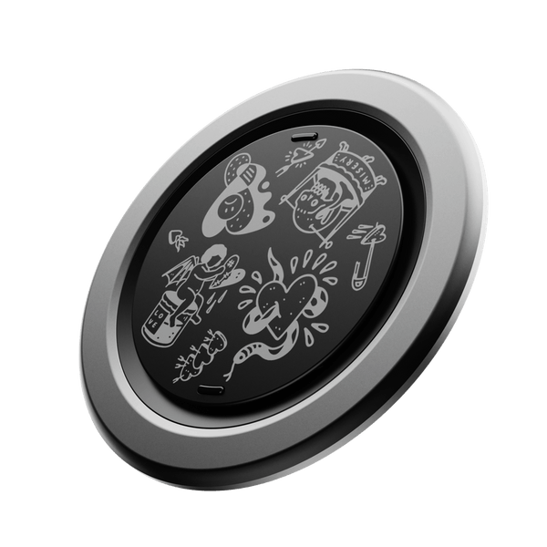 Circular grip with a black surface featuring various white doodles and a silver outer rim.