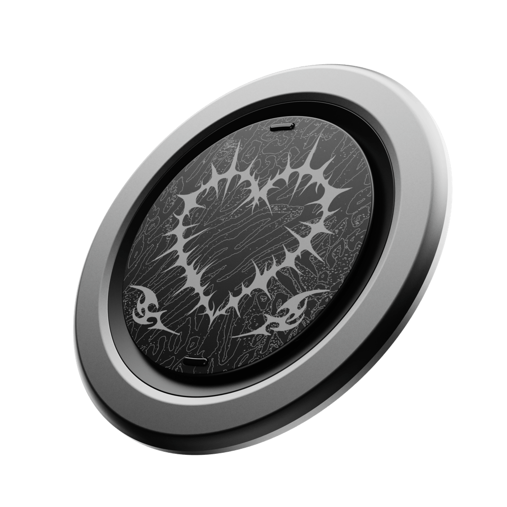 Round grip accessory with a black and silver design featuring a heart pattern and two skulls.