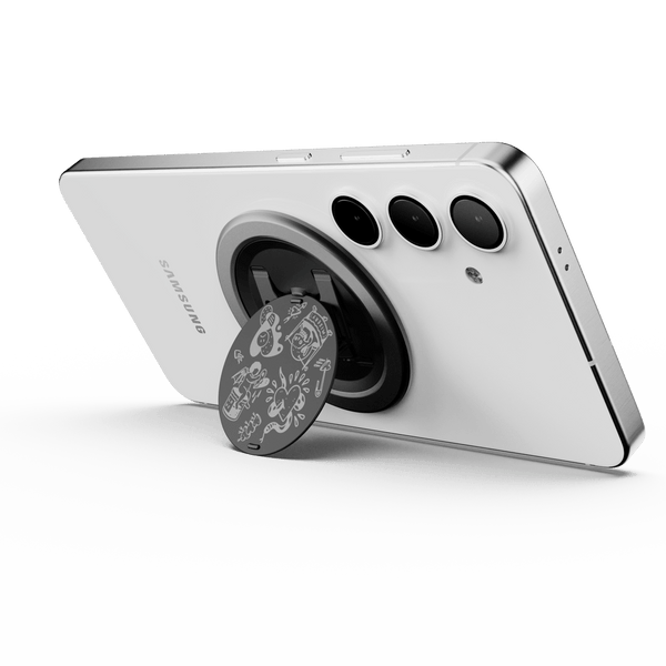 A smartphone with a circular grip attached to its back, featuring a decorative design.