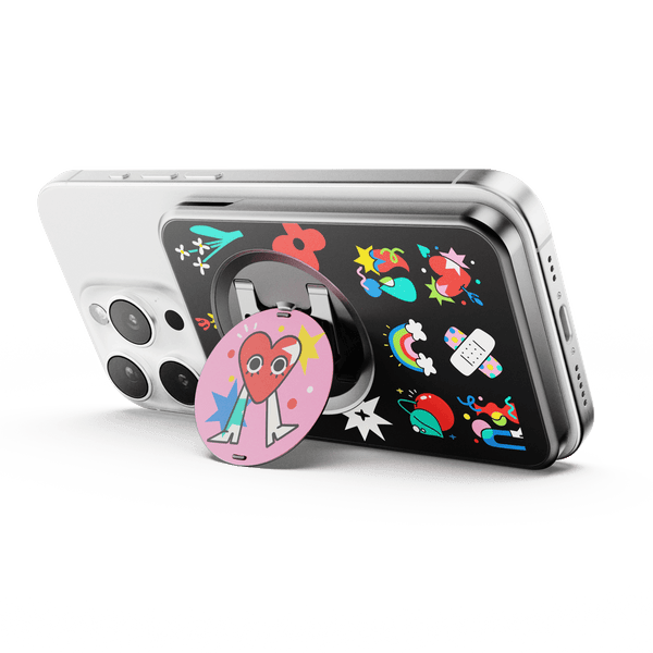 Wallet attachment on a smartphone featuring colorful stickers and a circular grip with a heart design.
