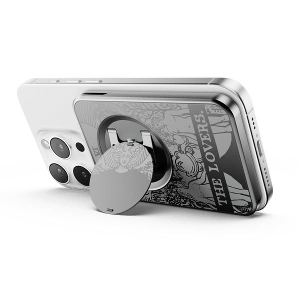 Wallet attachment on the back of a smartphone with a circular grip and decorative design.